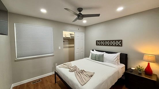 The first bedroom on the main floor comes with a queen size bed, Smart TV, bedside drawers with a light and device outlet. Bedding throughout the house is hotel style intended for better sleep.