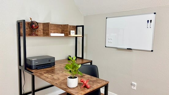 The workspace comes with office basics like a printer, starter supplies paper, folders, sticky pad, and even a white board.