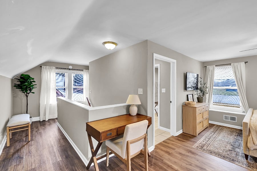 Upstairs bedroom with designated workspace.