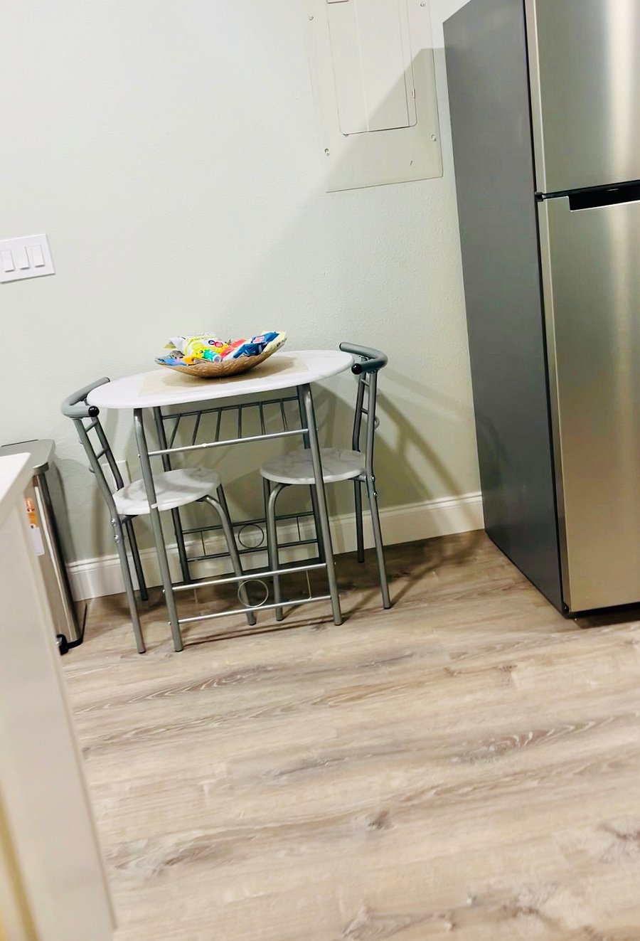 Cozy Space, table for 2, fruit basket, tall step stainless trash can.
