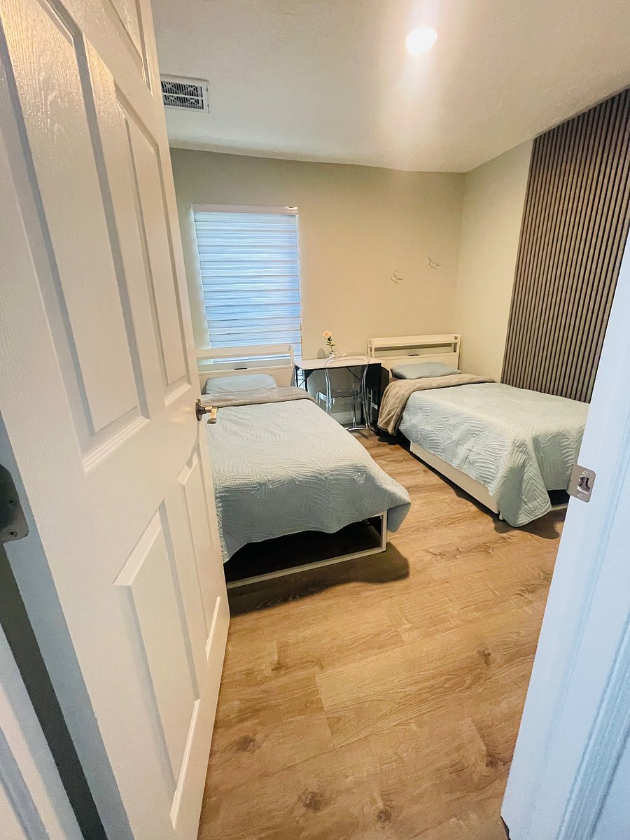 Room 2: with 2 twin beds, a desk with a chair, an under-the-bed shoe rack for extra storage, a wardrobe closet with 2 doors, a clothes rail, and 2 drawers. 