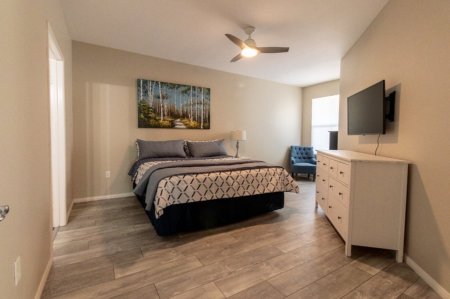 Master Bedroom with King Bed includes Bedding, 2 Dressers, Nightstand and Chair