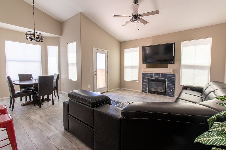 Open Concept Great Room with Gas Fireplace, Vaulted Ceilings, Ceiling Fan and adjoining Dining Area