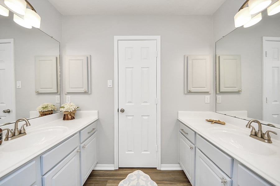 Guest bathroom with dual vanity area and separate room for shower/tub.