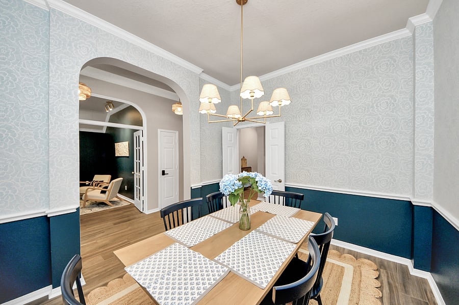 Updated modern dining room featuring fresh paint, a relaxed coastal boho vibe and a statement rattan dining light fixture that adds warmth and texture.