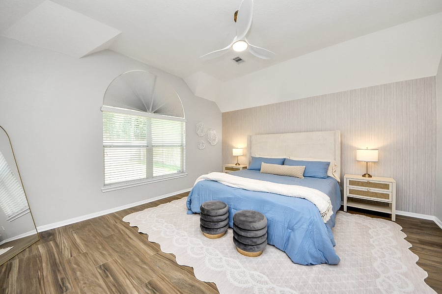 Primary bedroom with en-suite bathroom, King size bed, dresser and TV.