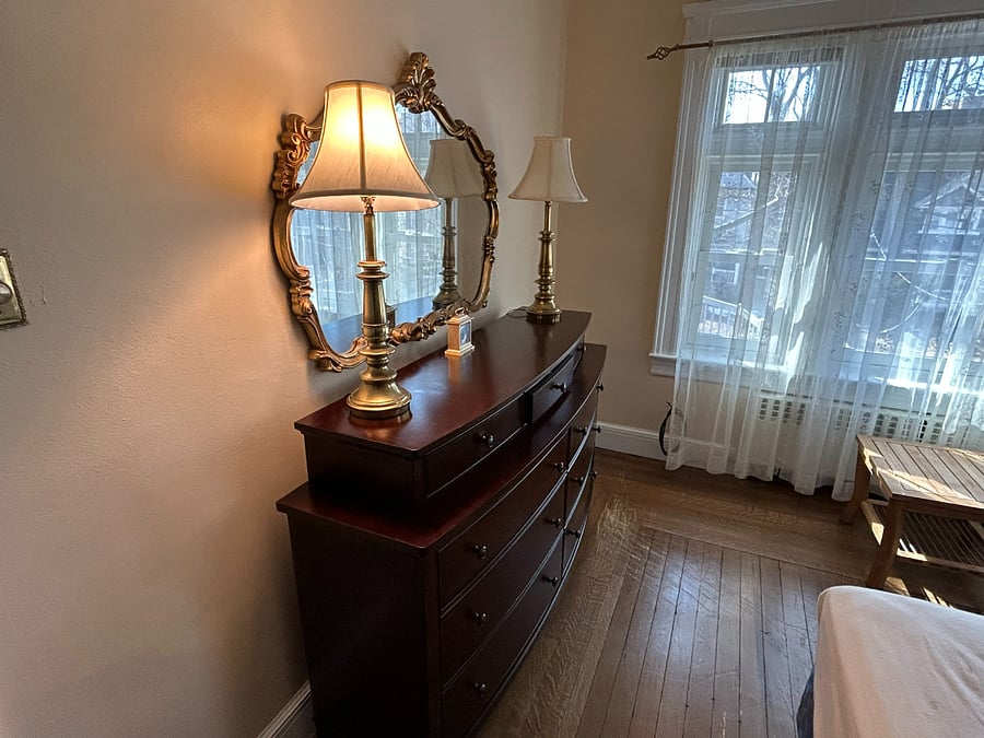 1st guest bed room, the "Vivienne".
View shown is upon entry.
Street view front of house seen.
Black out aluminum blinds are raised.
Small table in front of window replaces hope chest seen in other photo coming up showing the full size bed...