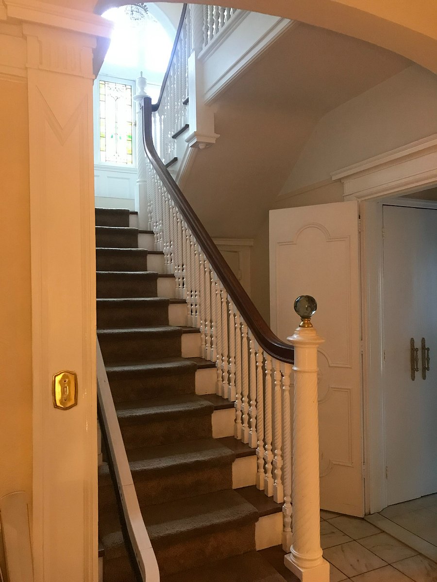 View of stairs leading up to the second floor.
Note the chair lift railing along the left side of stairs.