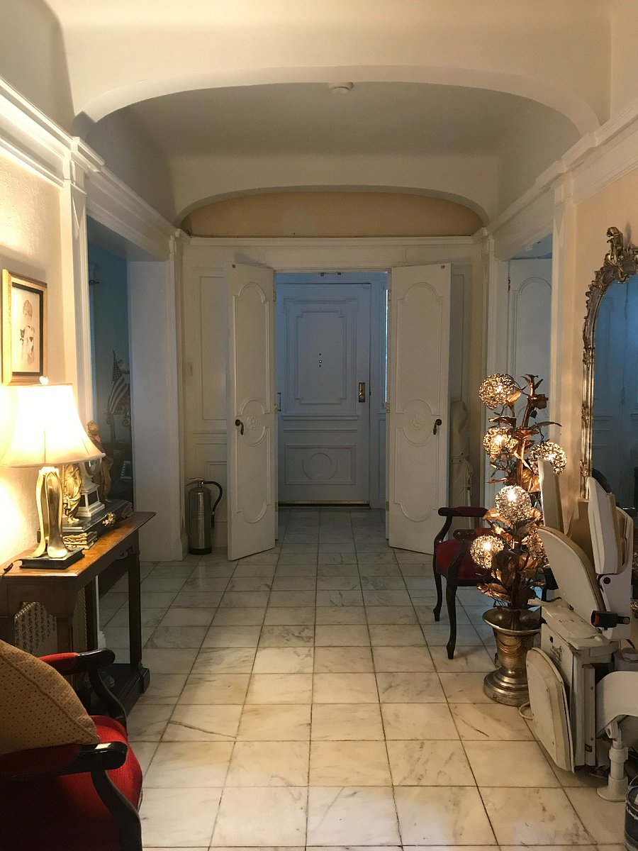 Main hall; first floor, reverse view, looking back at the front main door that is closed.
Note the chair lift on the right parked at the foot of the stairs leading up to the second floor bedrooms.