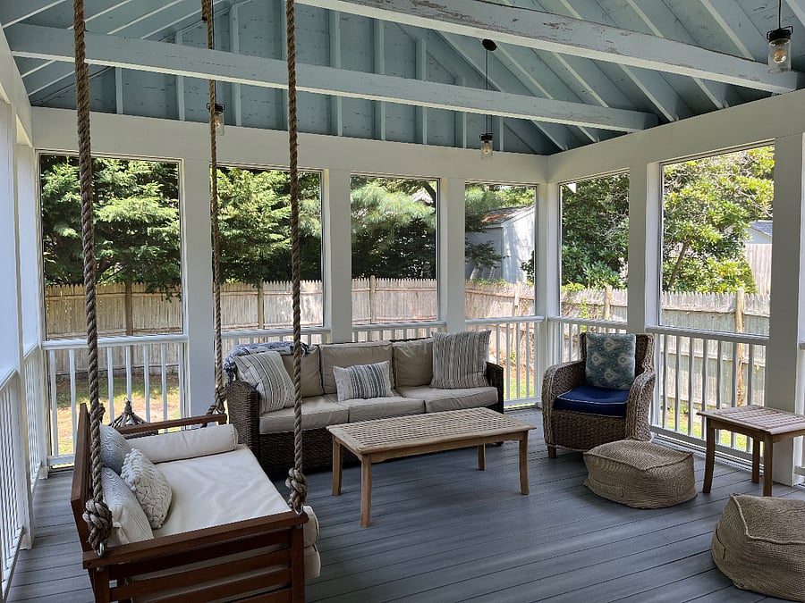 screened in porch with swing, couch and tv