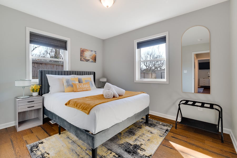 Relax in the comfort of a queen-sized bed dressed in luxurious linens, complete with a full-length mirror for added convenience and style. Perfect for a restful nights sleep or getting ready for the day ahead.
