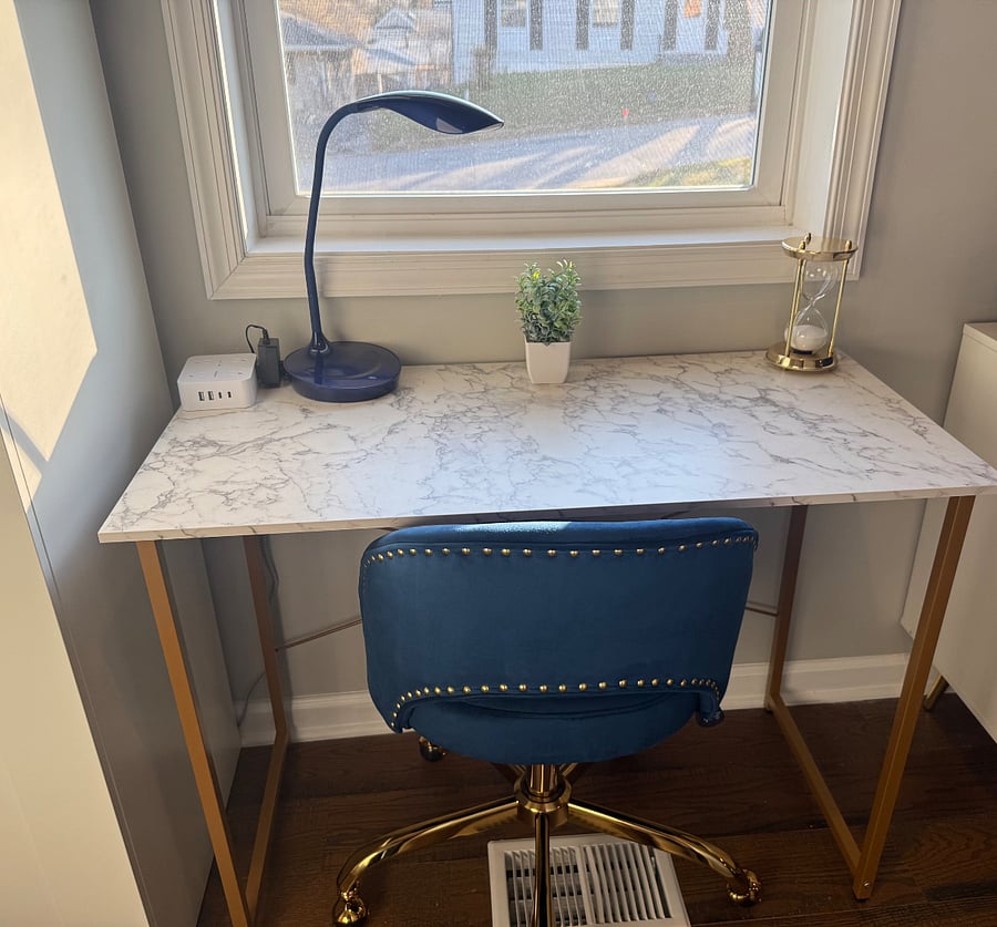 The workspace features a stylish, medium-sized desk, comfortable chair, and high-speed Wi-Fi, allowing you to seamlessly utilize the area for focused work or virtual meetings in a peaceful, well-lit environment.