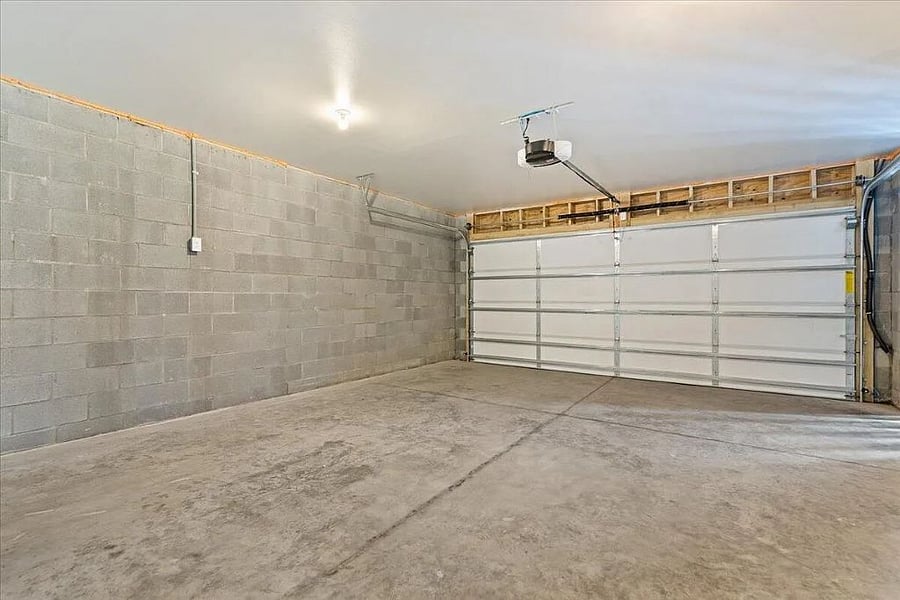 Spacious garage with automatic garage door opener. 