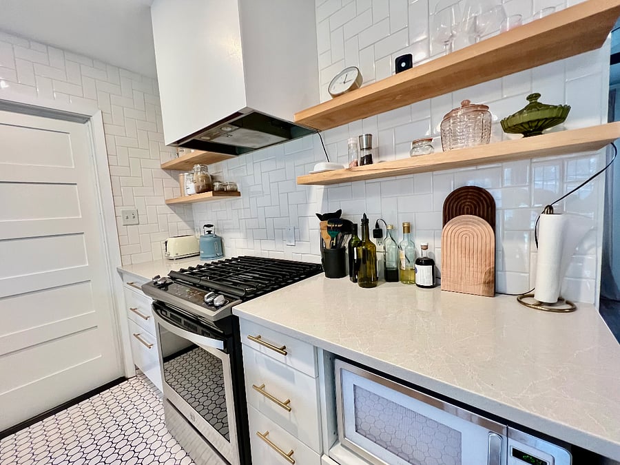 Oven, microwave, and door to the garage/ laundry space
