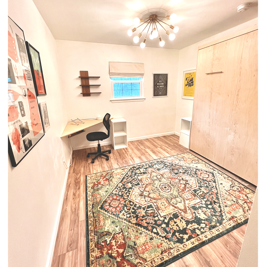 Guest Bedroom with laptop desk, fold-down queen bed and free weights good as a light workout or yoga space.