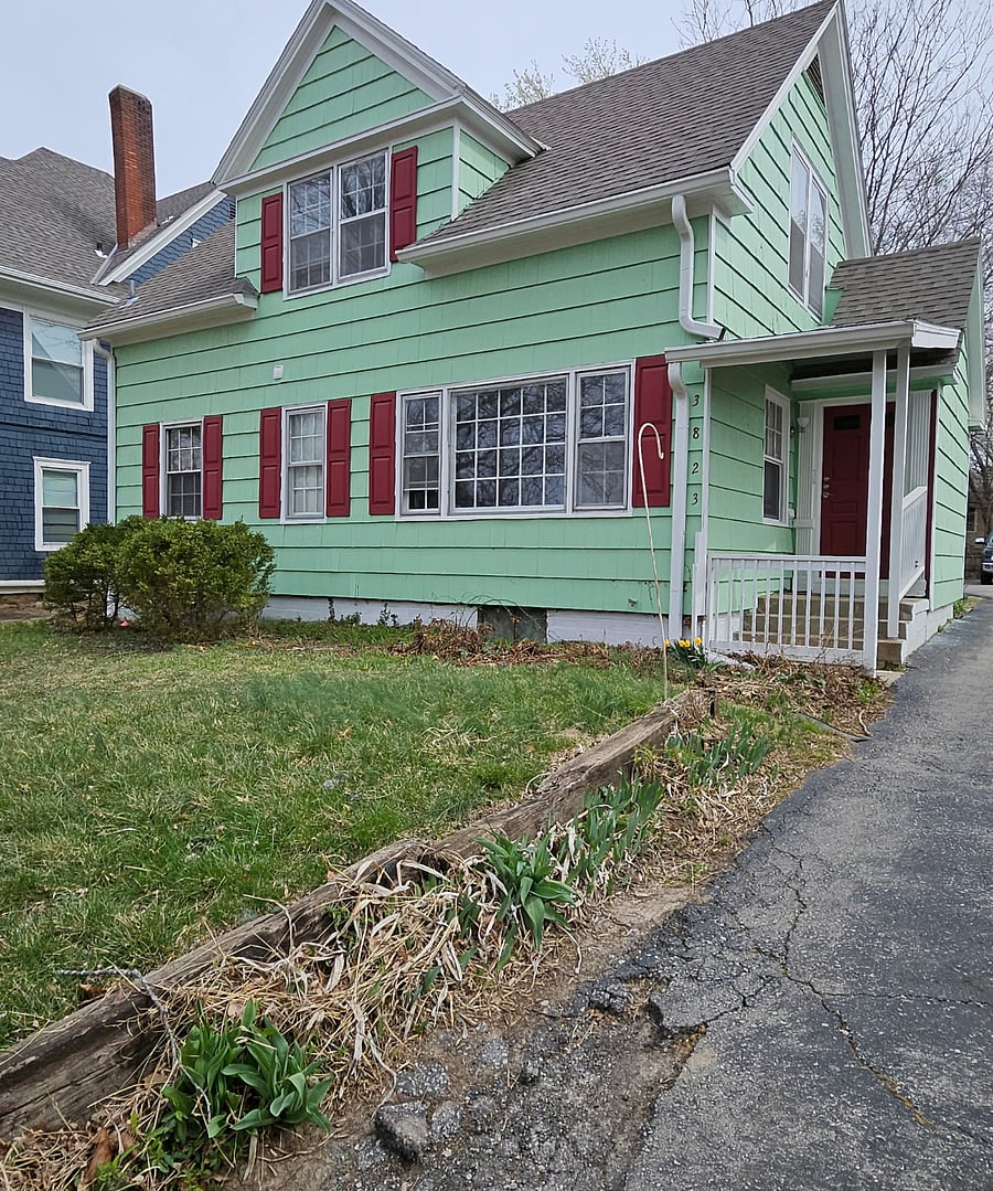 A Fresh Splash of Green: This vibrant green property brings energy and charm, creating a unique presence in the neighborhood.