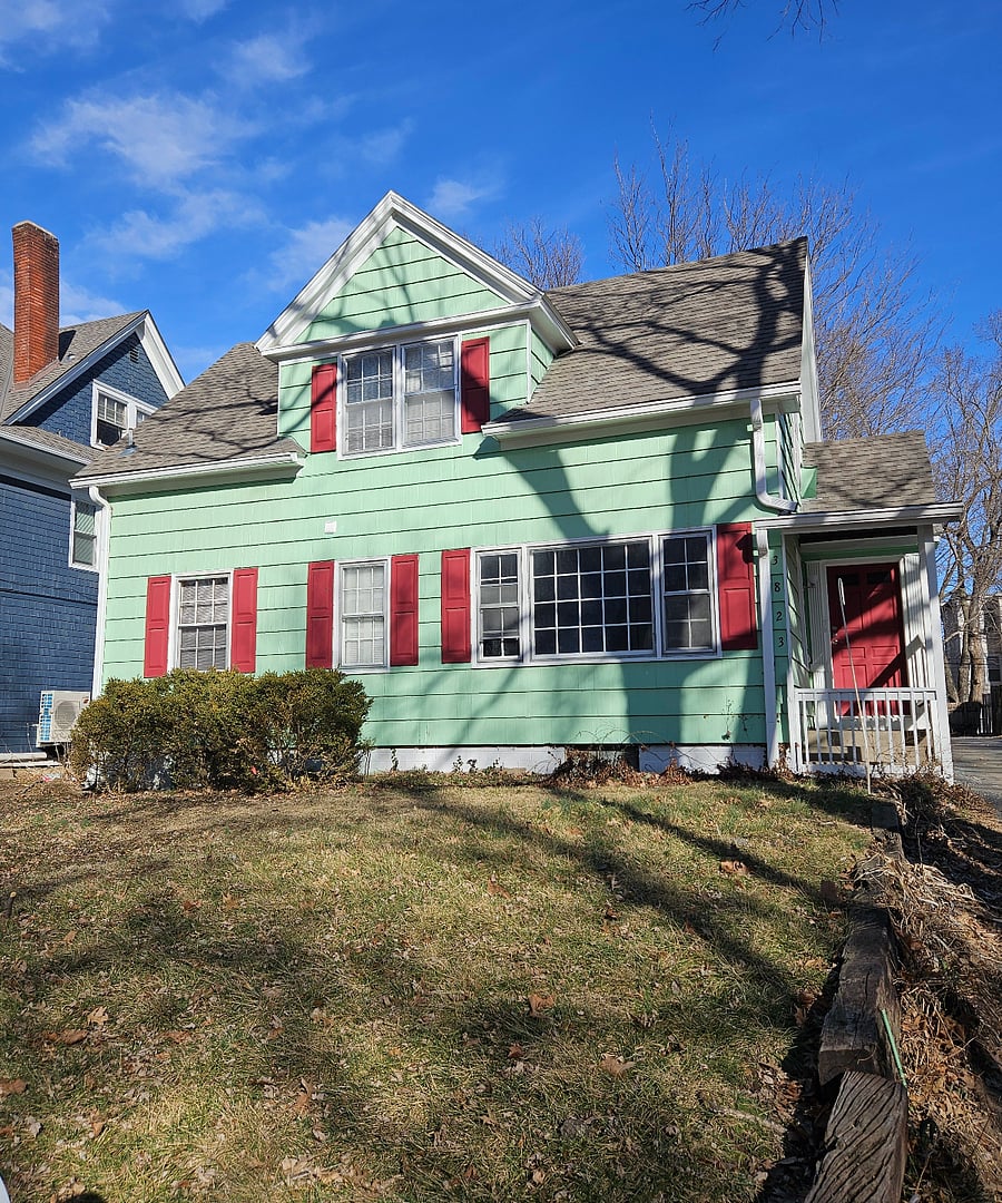 Vibrant & Convenient: This bright green gem stands out, with a shared driveway and easy access to local dining and KU Medical Center.