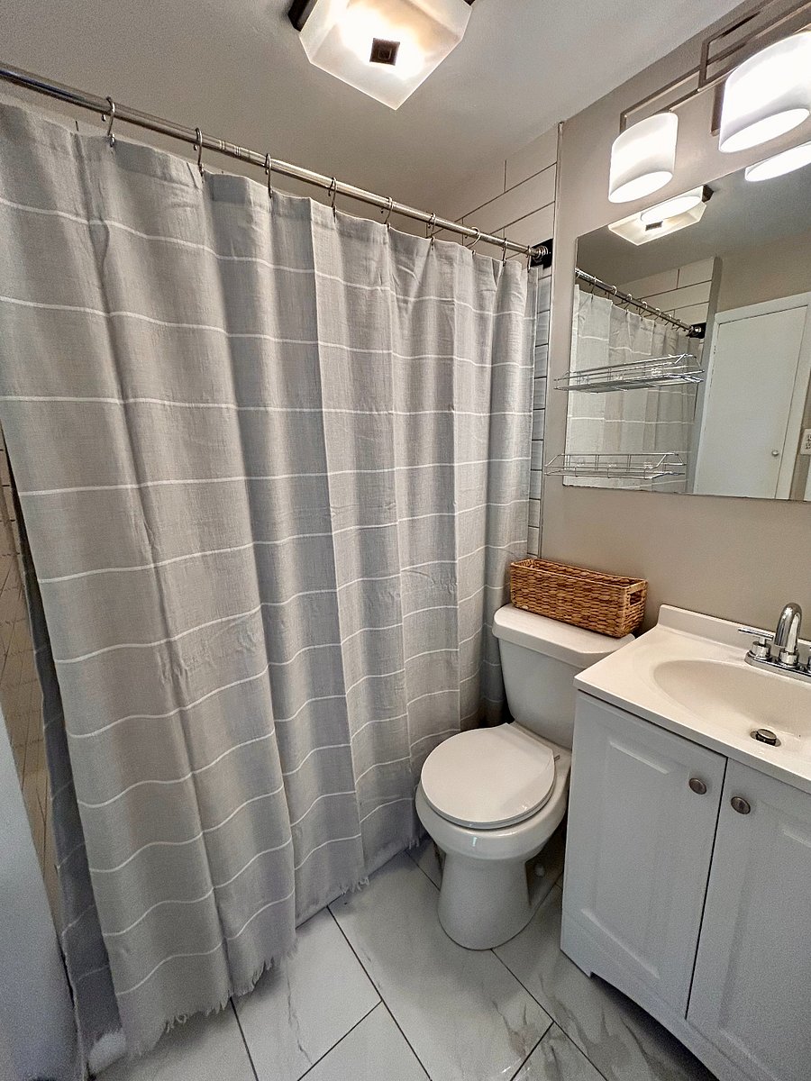 Effortless Style: Classic finishes and clever storage keep this bathroom looking tidy and timeless.