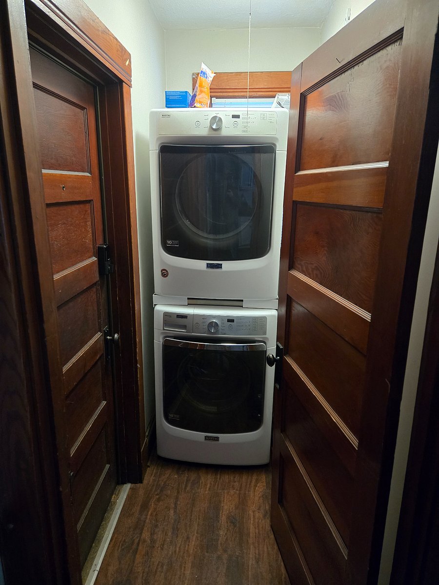 Washer and dryer located in the apartment by rear entrance