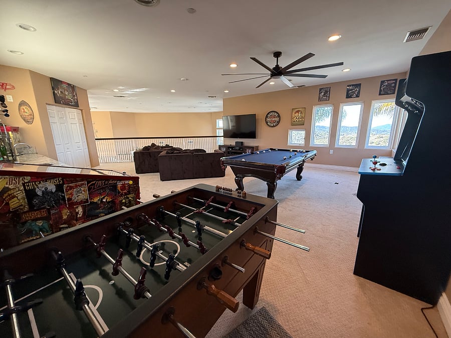 Game room with pinball machine, multicade, pool table, darts, and multiple video gaming consoles