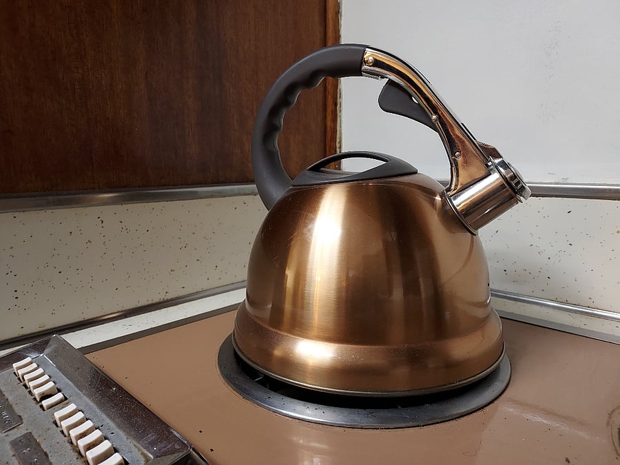 Kettle coordinates with original copper hardware.