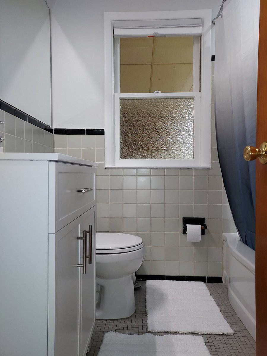 Vintage bath has a new toilet and vanity.