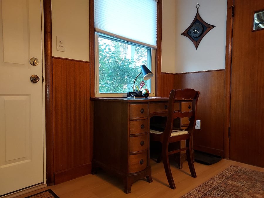 A desk is located in the dining area, off the kitchen.