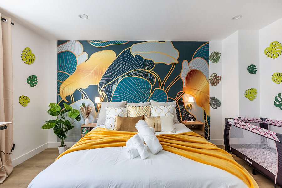Lush Leaf Room  Bold Style, Private Ensuite & Crib
Wake up surrounded by vibrant design in this eye-catching botanical-themed bedroom. With a dramatic tropical mural, luxe velvet textures, and a pop of golden yellow, this room brings resort-level style to your LA stay. Sink into the cozy queen bed with a plush comforter and a mountain of soft pillows for the perfect nights rest.

This room also features a private en-suite bathroom with modern finishes and is family-friendly with a portable crib/playpen includedideal for parents traveling with a little one.

 Bold tropical design & greenery
 Queen bed with velvet throw + accent pillows
 Private full bathroom (ensuite)
 Baby crib included
 Wall-mounted Smart TV
 Bright, airy vibe with blackout shades for comfort

Perfect for couples, solo travelers, or families with young children. This ones got style and comfort.