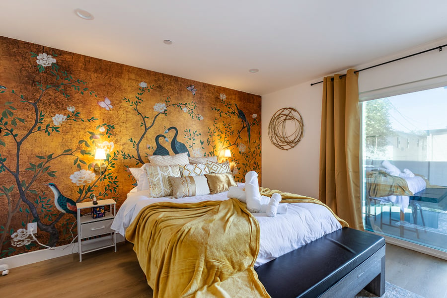 Golden Peacock Suite  Balcony Access, Fireplace & Luxe Decor
Welcome to our most elegant retreatwhere golden hues, rich textures, and serene art come together for a truly regal experience. This spacious bedroom features a plush queen bed surrounded by shimmering golds, a stunning hand-painted peacock mural, and a cozy fireplace for added ambiance.

Enjoy your morning coffee or an evening wind-down on the private balcony, or curl up in the velvet lounge chair with one of the included board games. This room is also equipped with a vanity station, full-length mirror, Smart TV, and plenty of open space for relaxing or getting ready.

 Luxe queen bed with gold-accented pillows & blanket
 Built-in electric fireplace
 Private balcony with outdoor seating
 Lighted vanity & full-length mirror
 Board games & Smart TV
 Ensuite private bathroom
 Velvet lounge chair + footrest

This suite is perfect for couples or solo travelers looking for a luxurious, hotel-style experience in a peaceful, private space.

