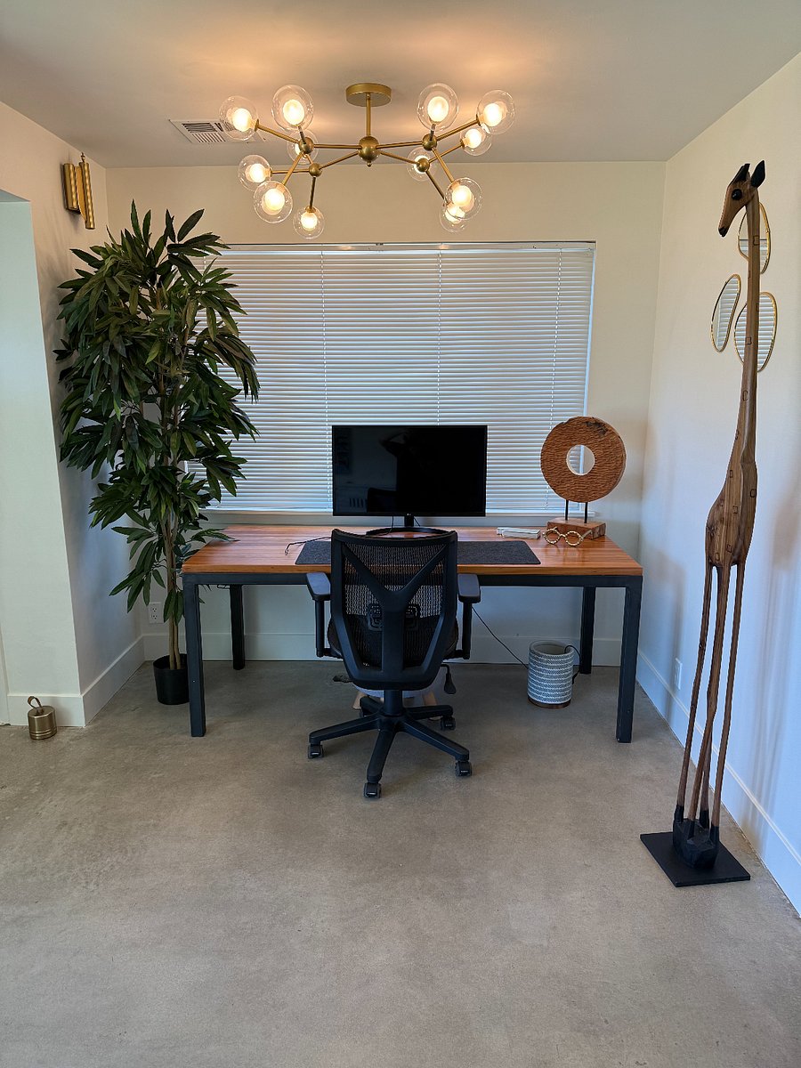 Workspace with desk, office chair, and external monitor (located in front living/dining room)