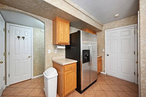 View from kitchen to the half bathroom (left door) and the garage (right door)