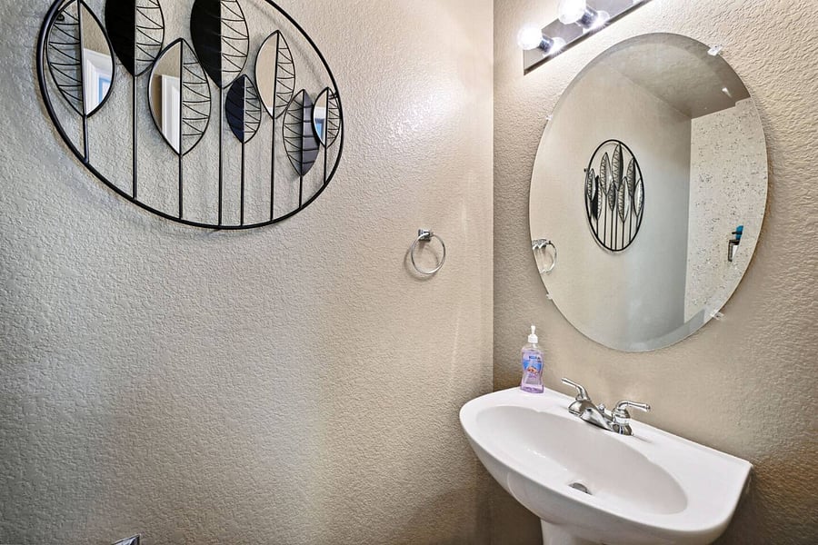 Half bathroom; view of sink and wall decor.