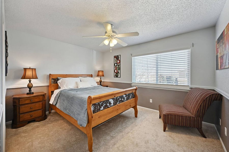 Main bedroom with a queen size bed. Has walk-in closet and full bathroom/shower.