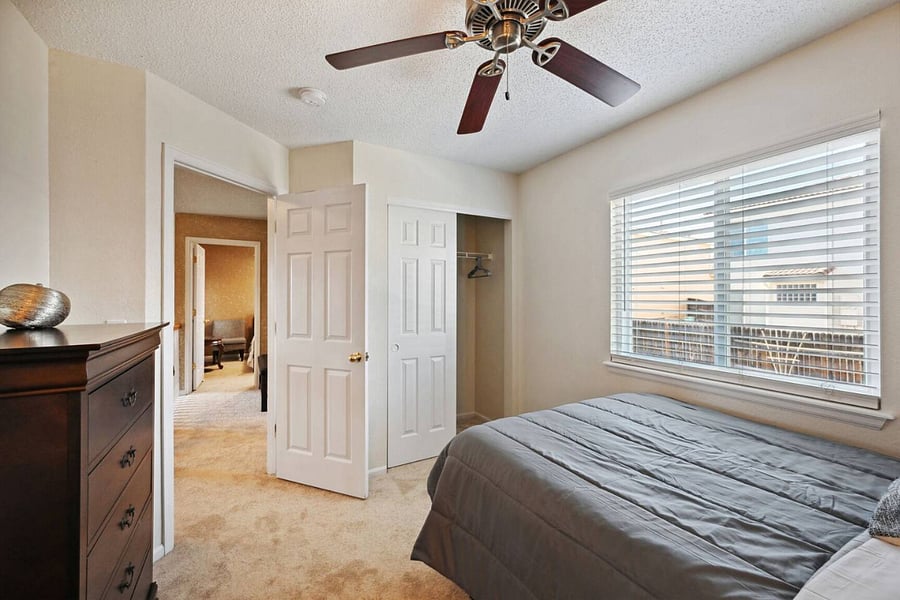 Second bedroom with full size bed, facing entry door and closet.