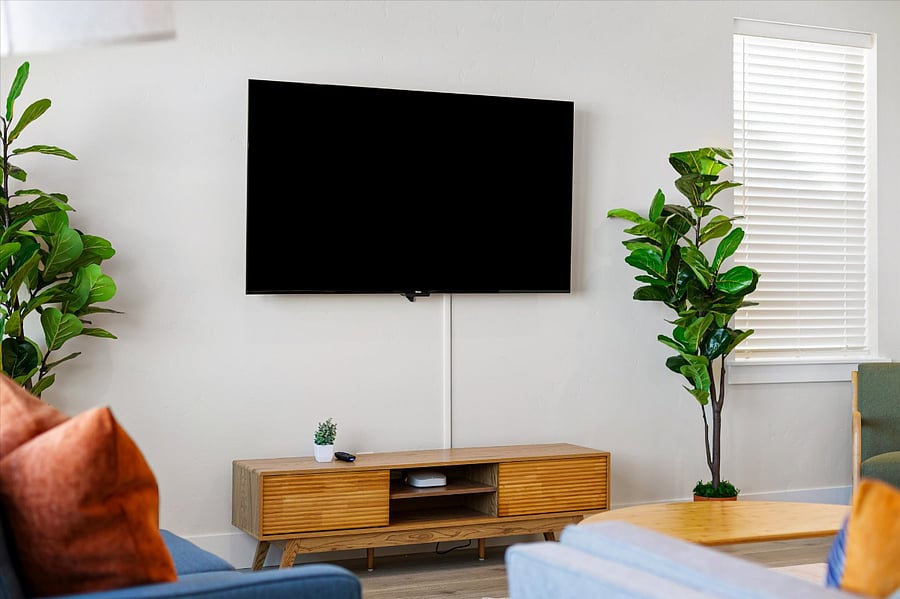 Living room features smart RokuTV. Login to your favorite apps.