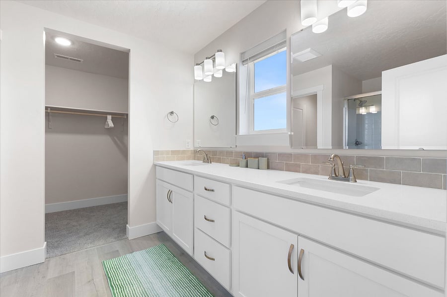 Master bathroom features double sinks, shower and large walk in closet.