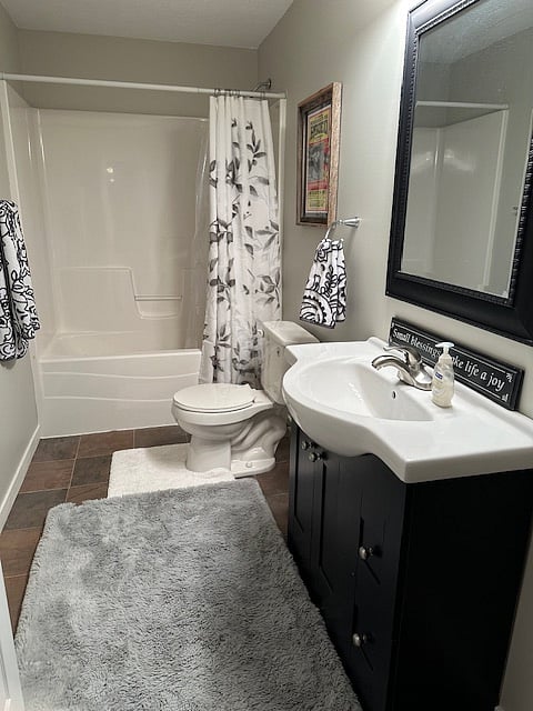 Clean, private bathroom next to bedroom and living space.