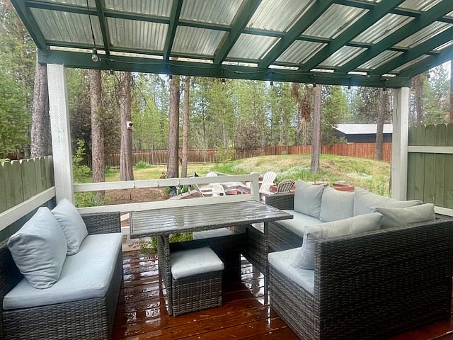 Covered backyard patio with comfortable seating, perfect for working remotely or entertaining guests.