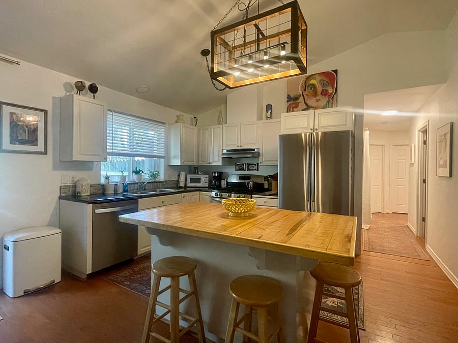 Well-lit kitchen featuring an island thats perfect for hosting and prepping meals.