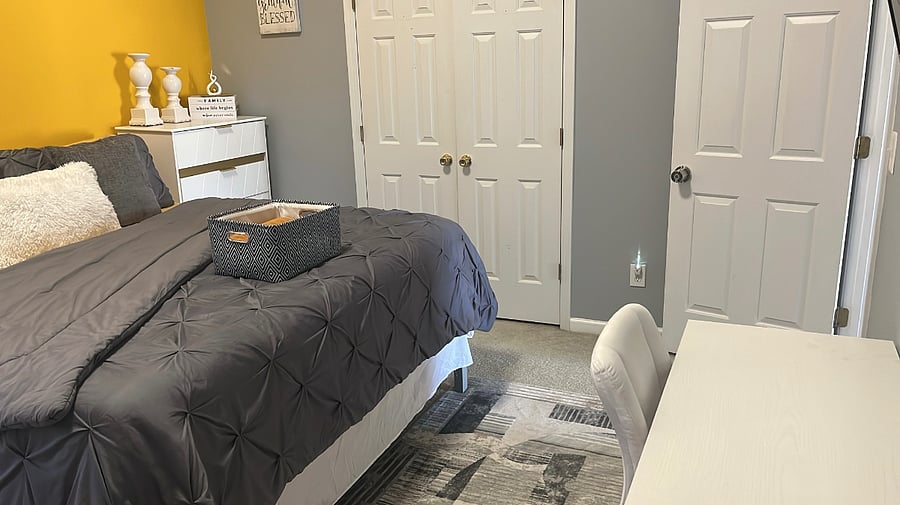 Guest bedroom-King sized bed, desk, smart TV, futon couch, laundry basket, ironing board, iron, dresser, towels & toiletries.
