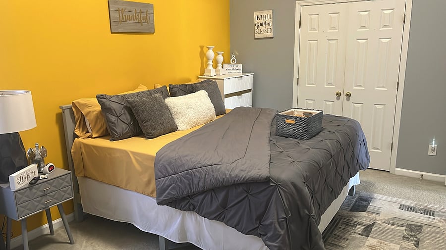 Guest bedroom-King sized bed, desk, smart TV, futon couch, laundry basket, ironing board, iron, dresser, towels & toiletries.