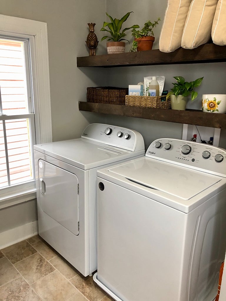 Brand new washer/dryer and plenty of storage with open shelving, cabinets, and coat hooks.