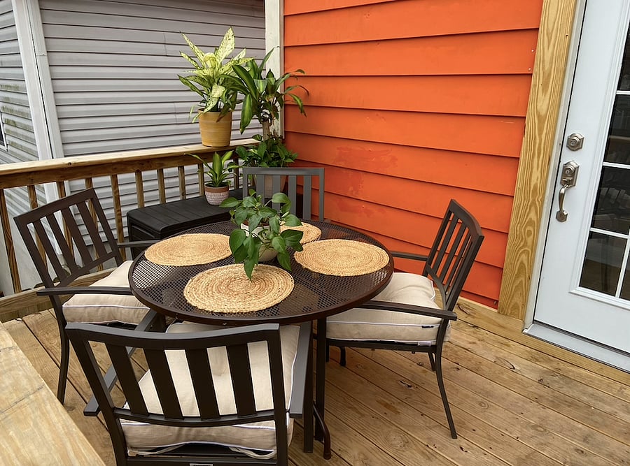 The new deck comfortably seats 4; stairs take you to the back yard and parking area.