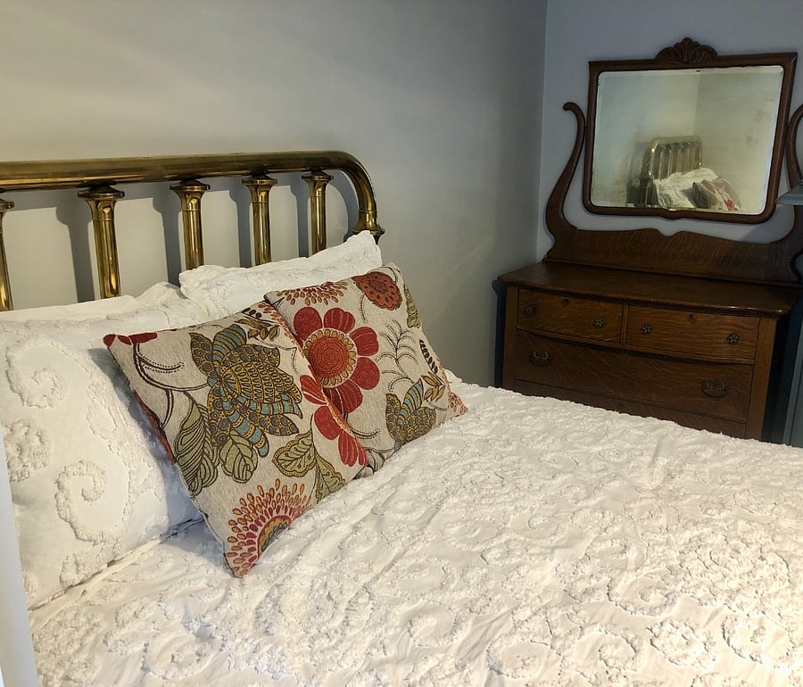 Brass bed (full-sized with new memory foam mattress) and oak dresser in the front bedroom.