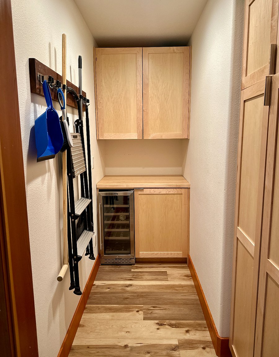 Pantry with ample storage, and wine fridge.