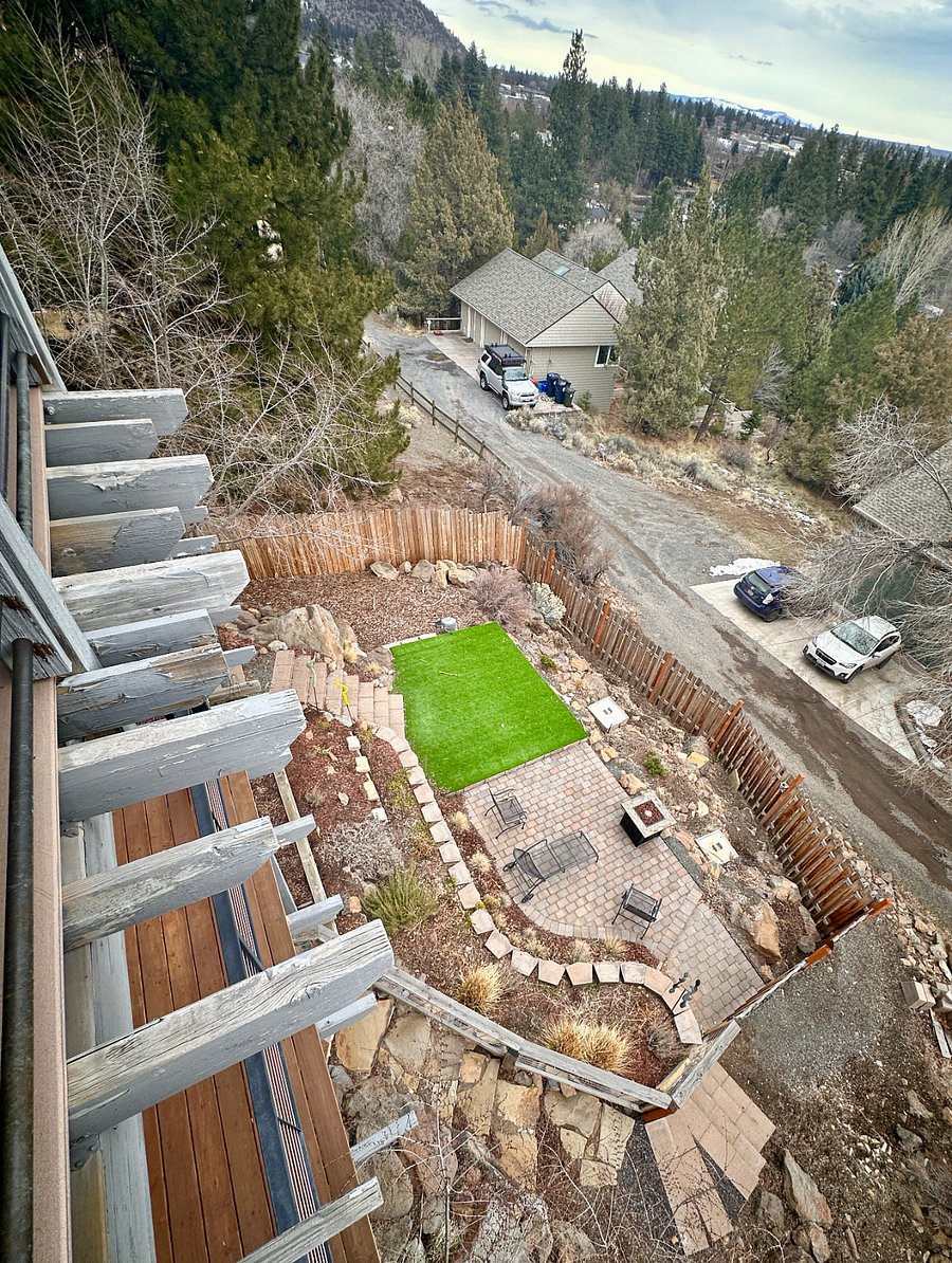 View of fenced backyard from upper deck. Dog run along the side of the house, not pictured.