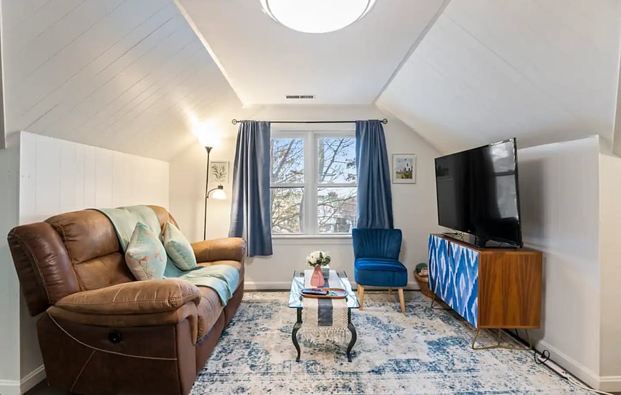 Cozy living room with a plush sofa and large windows offering plenty of natural light. There is a Roku TV for your streaming needs!