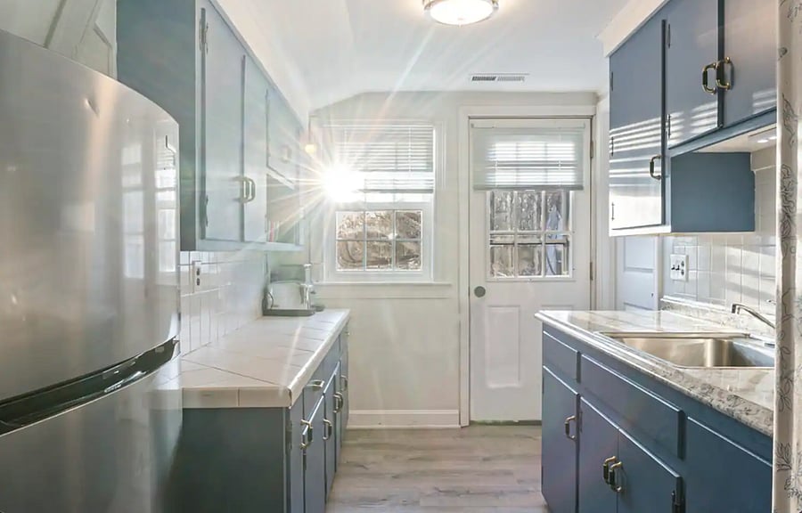 The modern blue kitchen has everything you need. It is fully equipped with all the appliances and has plenty of counter space. 