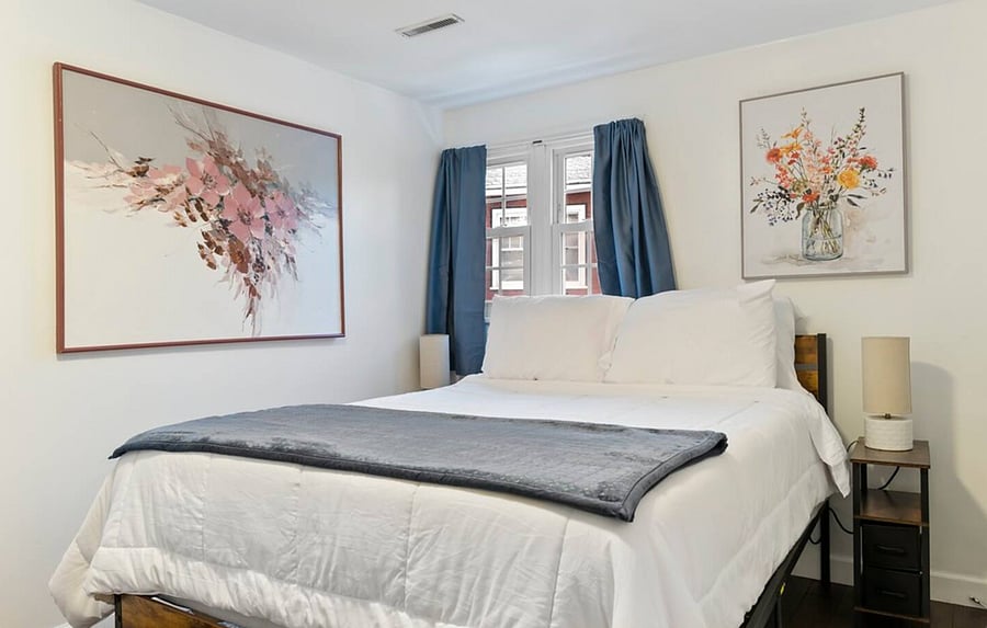 Flower bedroom with a plush queen-size bed and closet space. 