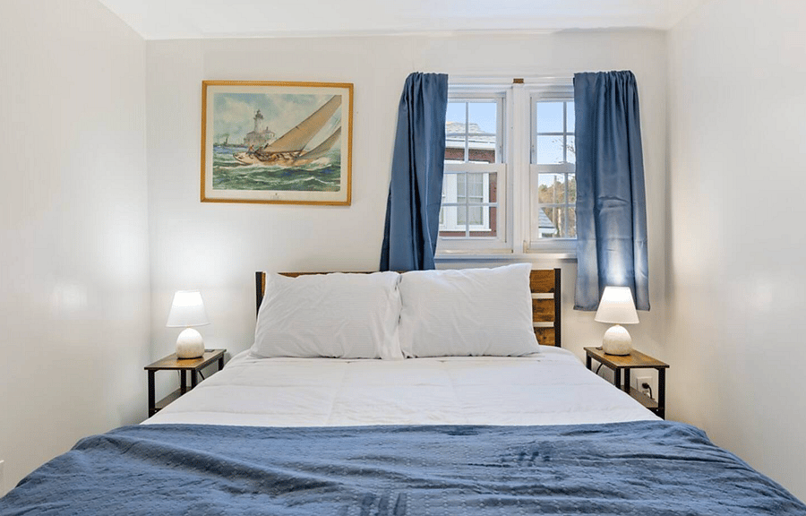 The second bedroom has a plush queen-sized bed, closet space, and plenty of natural sunlight. 